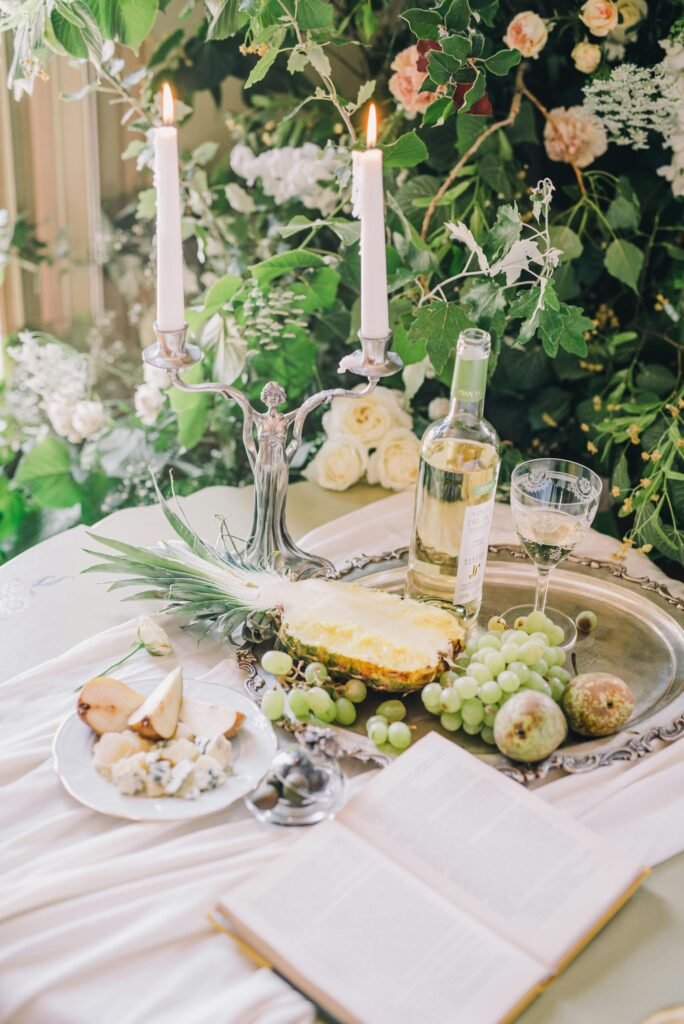 Luxurious table setting with wine, fruits, and candles, exuding elegance and relaxation.